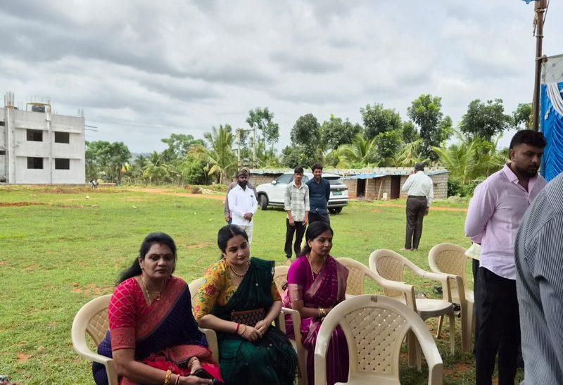 Guests gather, the academic block behind them